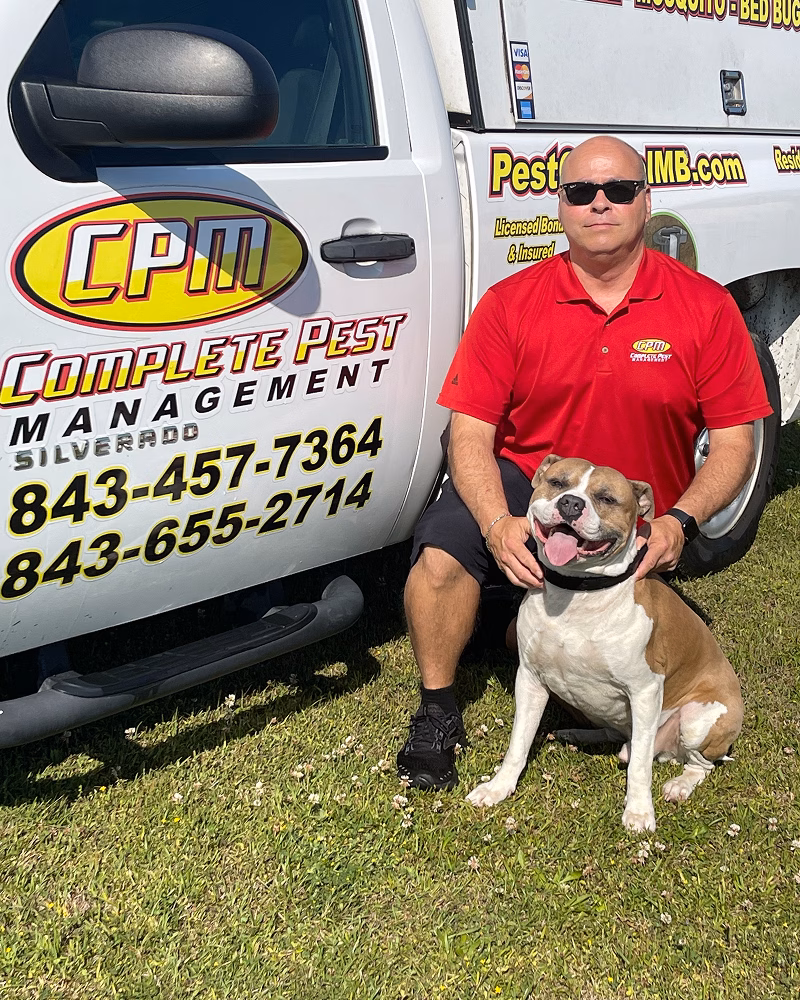 Gerald and his dog sitting in front of company van